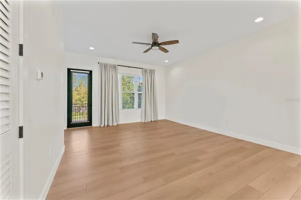 a view of a kitchen with kitchen island stainless steel appliances wooden floor and window
