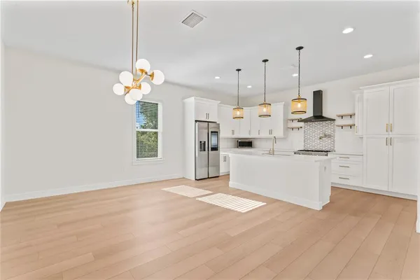 a very nice looking room with a chandelier furniture and windows