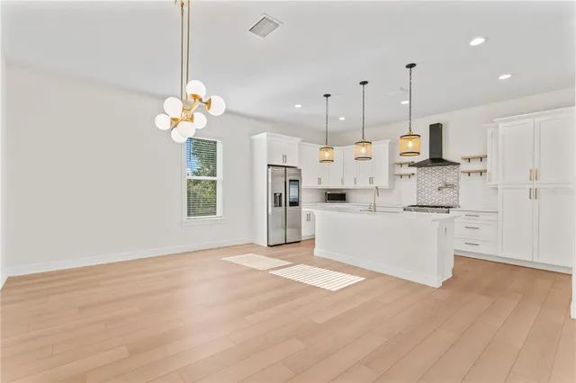 a very nice looking room with a chandelier furniture and windows