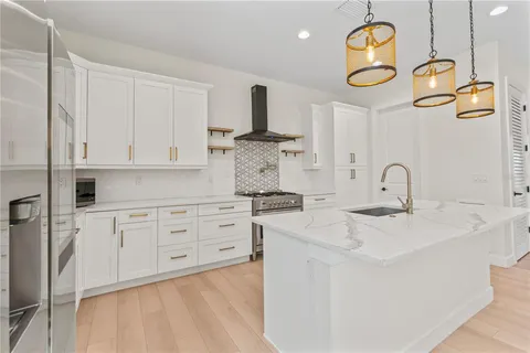 a kitchen with a sink a stove and a refrigerator