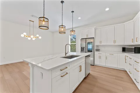 a kitchen with cabinets and stainless steel appliances