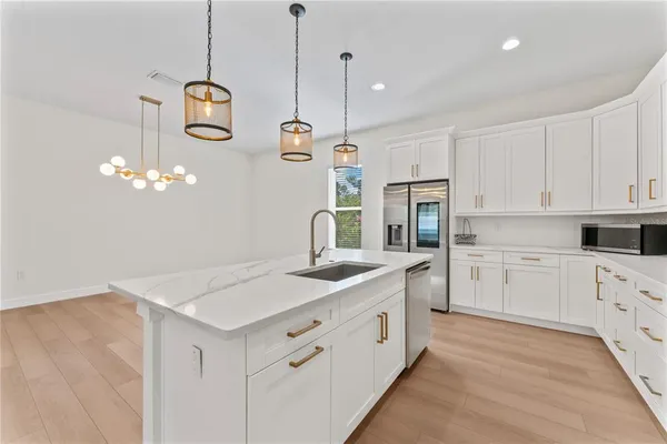 a kitchen with cabinets and stainless steel appliances