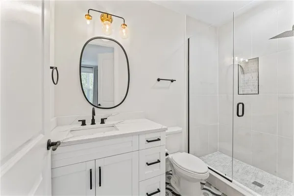 a bathroom with a sink toilet and shower