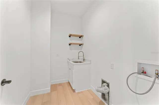a view of empty room with wooden floor and a ceiling fan