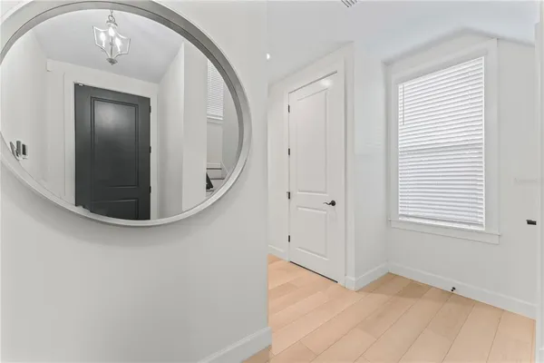 a view of a livingroom with wooden floor and staircase