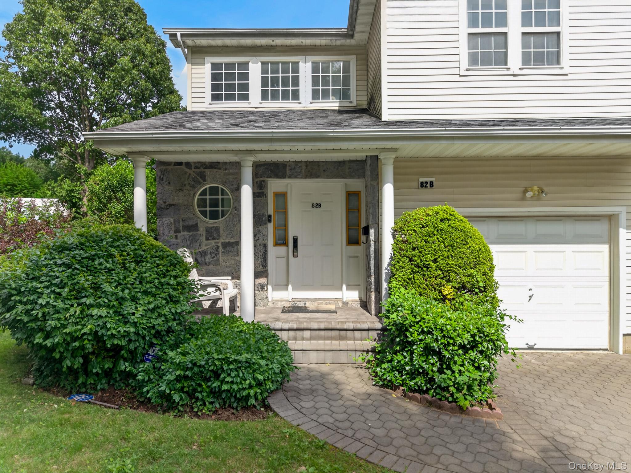 82 B Inwood Road Port Washington, NY 11050 - Photo 3 of 41 a front view of a house with garden