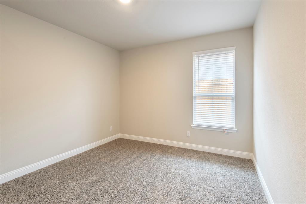 2301 Ruff Road Denton, TX 76205 - Photo 16 of 23 Neutral-toned interior room featuring light gray carpeting, white baseboards, and a single window with white blinds