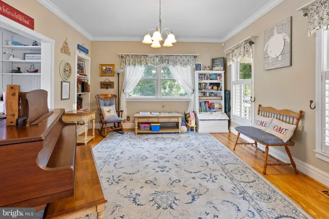 a living room with furniture a fireplace and a chandelier
