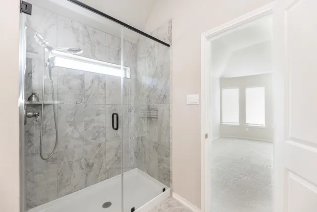 a bathroom with a shower and a bath tub