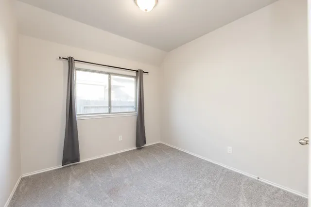 a view of an empty room and a window