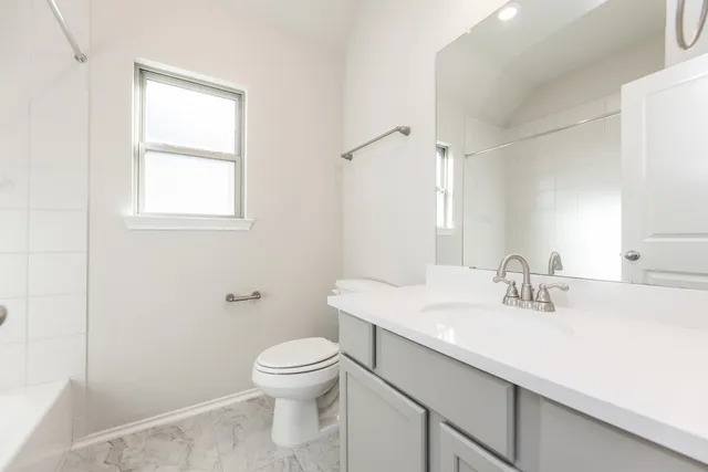 a bathroom with a sink toilet and vanity