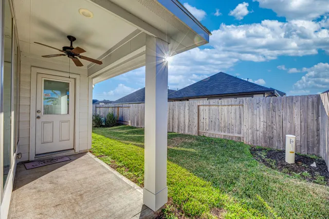 a view of a house with backyard and porch