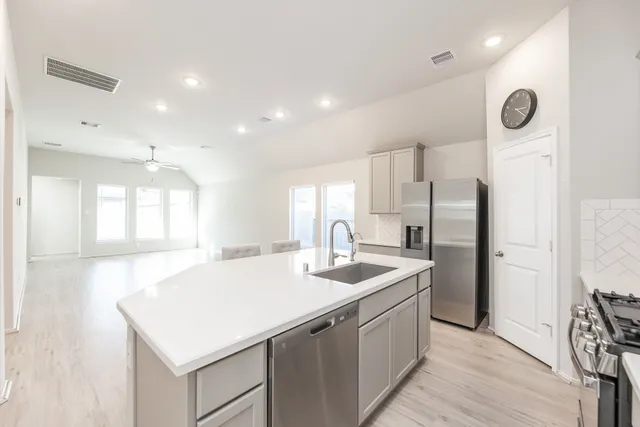 a kitchen with a sink and a refrigerator