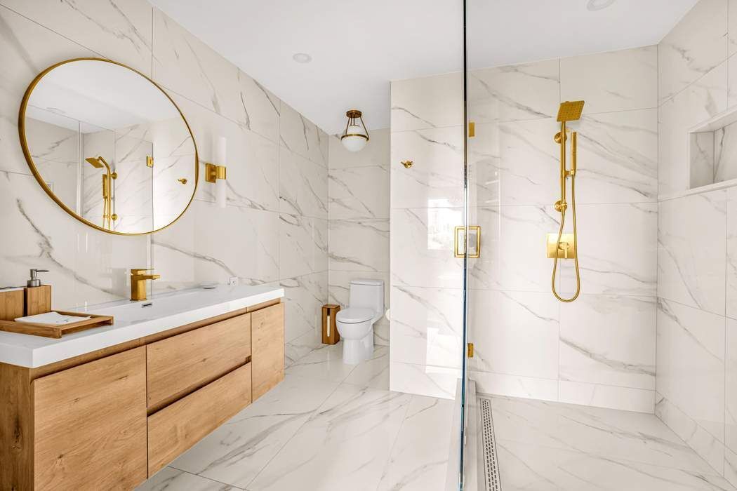 860 5th Avenue, Unit 9/10JK Manhattan, NY 10065 - Photo 11 of 19 a bathroom with a sink and mirror