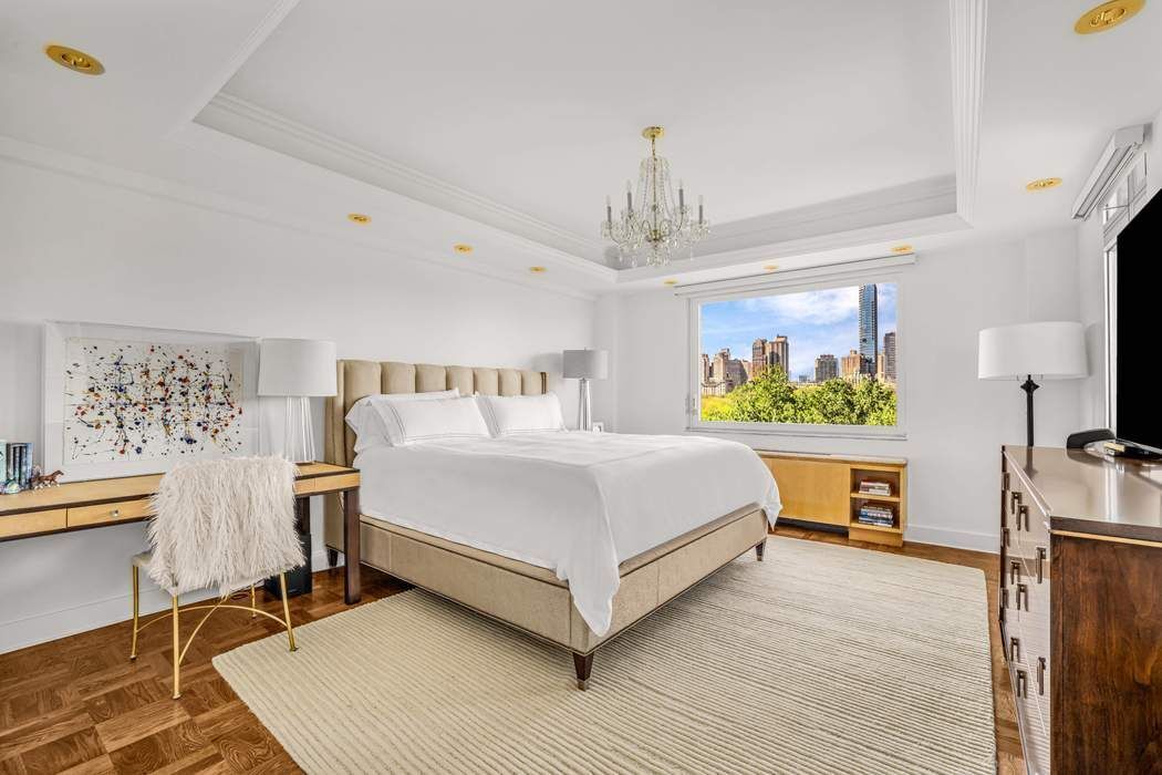 860 5th Avenue, Unit 9/10JK Manhattan, NY 10065 - Photo 13 of 19 a bedroom with a bed table closet and a lamp