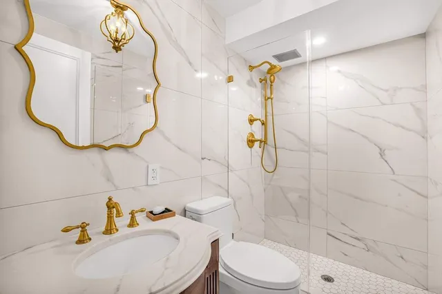 a bedroom with a bed table closet and a lamp