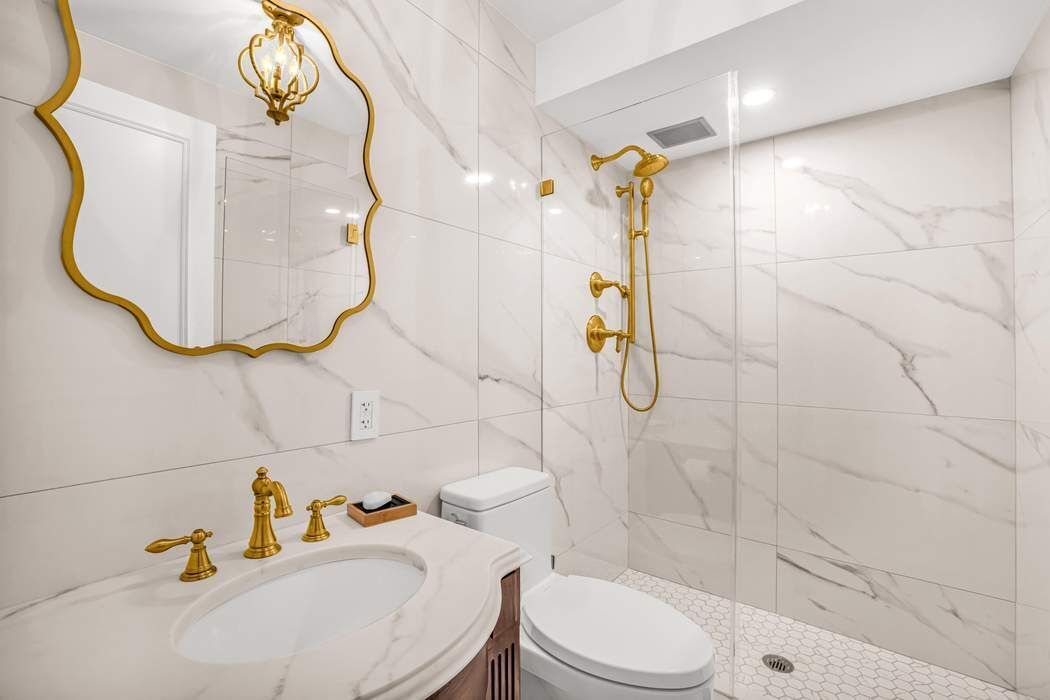 860 5th Avenue, Unit 9/10JK Manhattan, NY 10065 - Photo 14 of 19 a bathroom with a sink toilet and shower