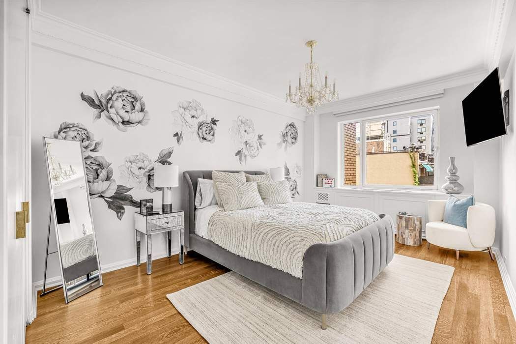 860 5th Avenue, Unit 9/10JK Manhattan, NY 10065 - Photo 16 of 19 a bedroom with a large bed and a window