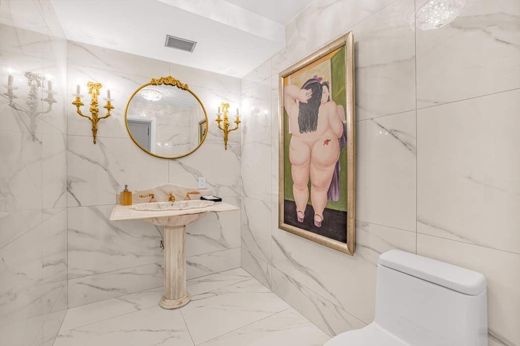 860 5th Avenue, Unit 9/10JK Manhattan, NY 10065 - Photo 17 of 19 a bathroom with a sink mirror vanity and toilet