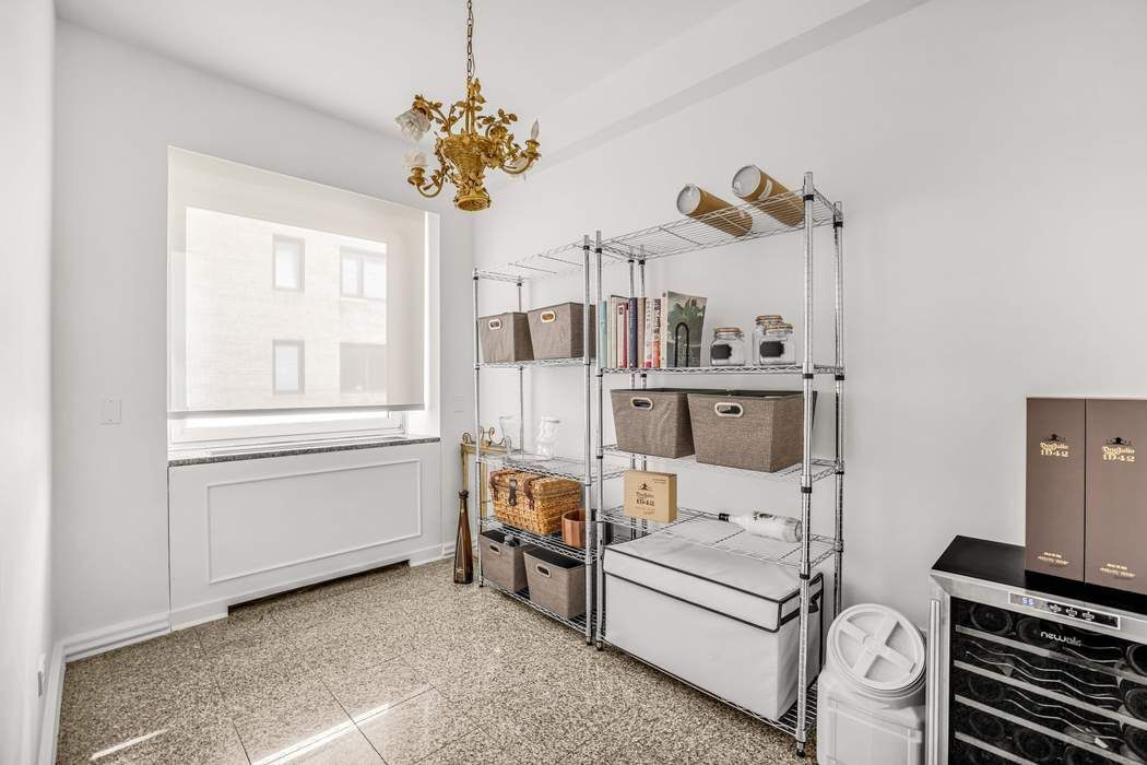 860 5th Avenue, Unit 9/10JK Manhattan, NY 10065 - Photo 18 of 19 a living room with furniture and a chandelier