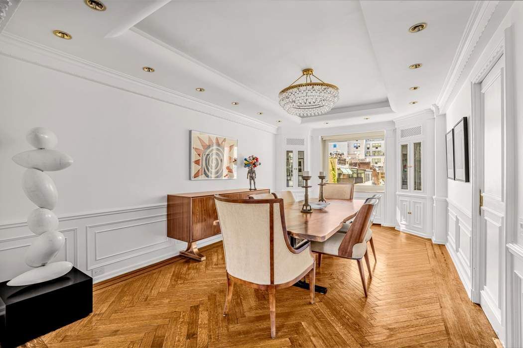 860 5th Avenue, Unit 9/10JK Manhattan, NY 10065 - Photo 6 of 19 a view of a dining room with furniture and wooden floor