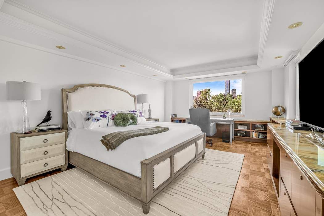 860 5th Avenue, Unit 9/10JK Manhattan, NY 10065 - Photo 9 of 19 a bed room with a bed and a television