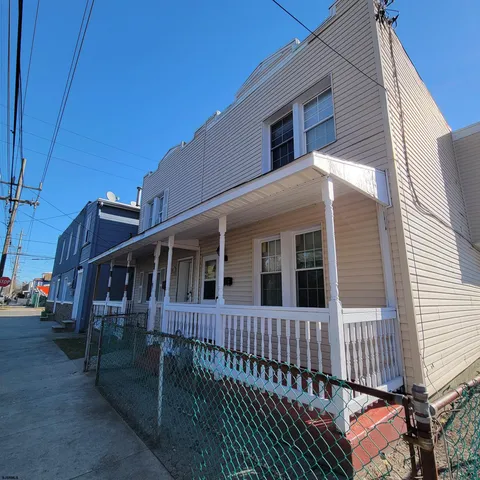 a view of a house with wooden fence