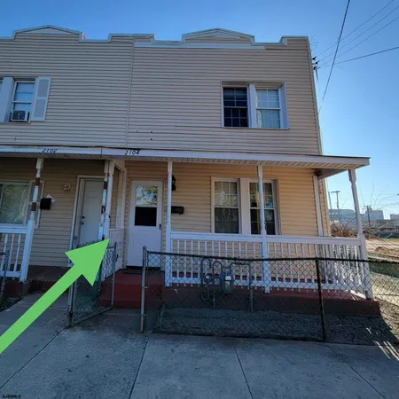 a view of a house with wooden fence