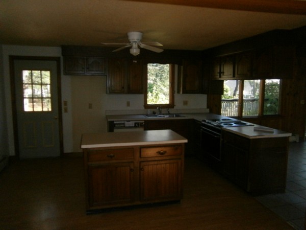 20 Dexter Street Eastham, MA 02642 - Photo 3 of 14 a kitchen with a sink window and cabinets