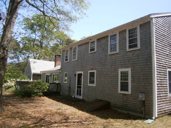 20 Dexter Street Eastham, MA 02642 - Photo 4 of 14 a front view of a house with a yard