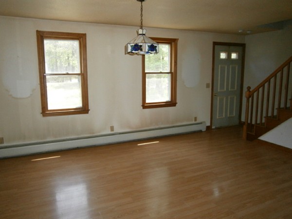 20 Dexter Street Eastham, MA 02642 - Photo 8 of 14 an empty room with wooden floor and windows