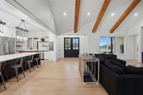 a living room with stainless steel appliances kitchen island granite countertop furniture and a kitchen view