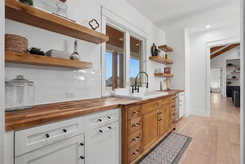 a kitchen with cabinets and window