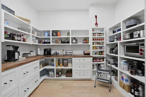 a kitchen with stainless steel appliances cabinets and a book shelf