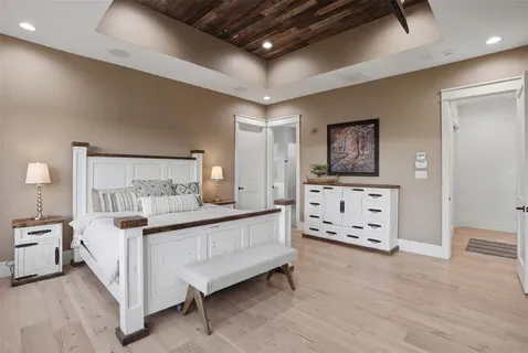 a bed room with furniture and painting on the wall