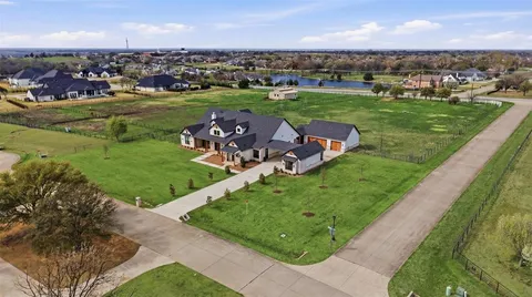 an aerial view of a house with outdoor space