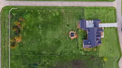 an aerial view of residential houses with outdoor space and street view