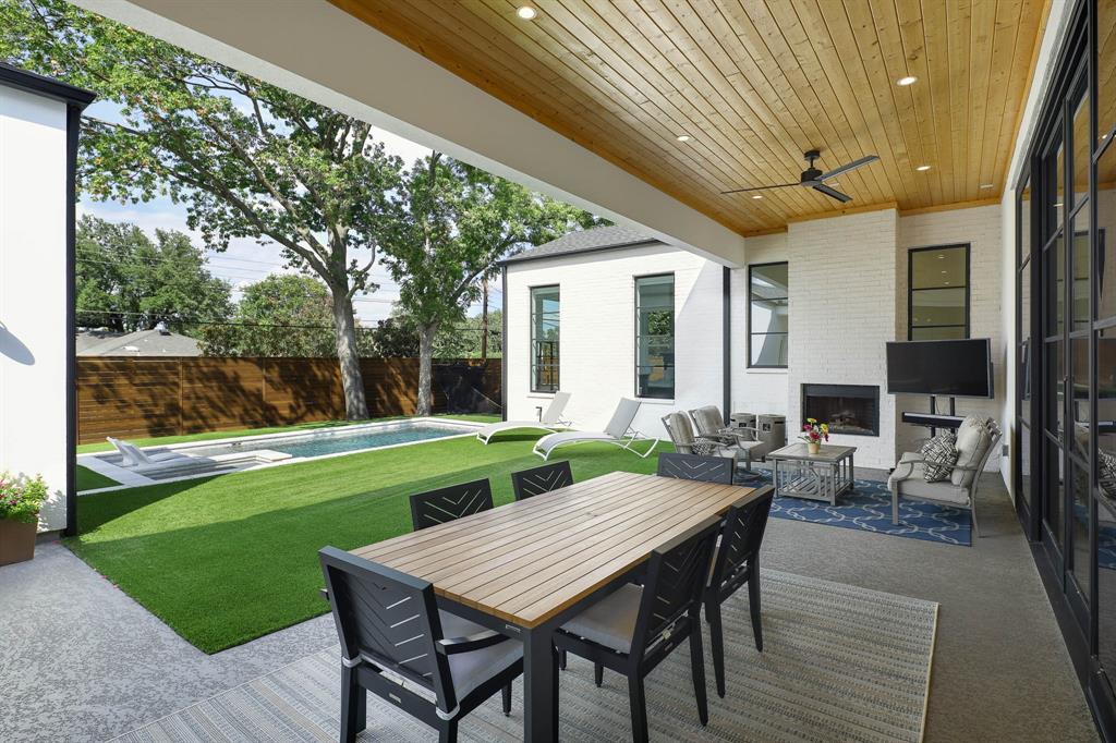 7149 Northaven Road Dallas, TX 75230 - Photo 20 of 25 a view of a patio with table and chairs potted plants and floor to ceiling window