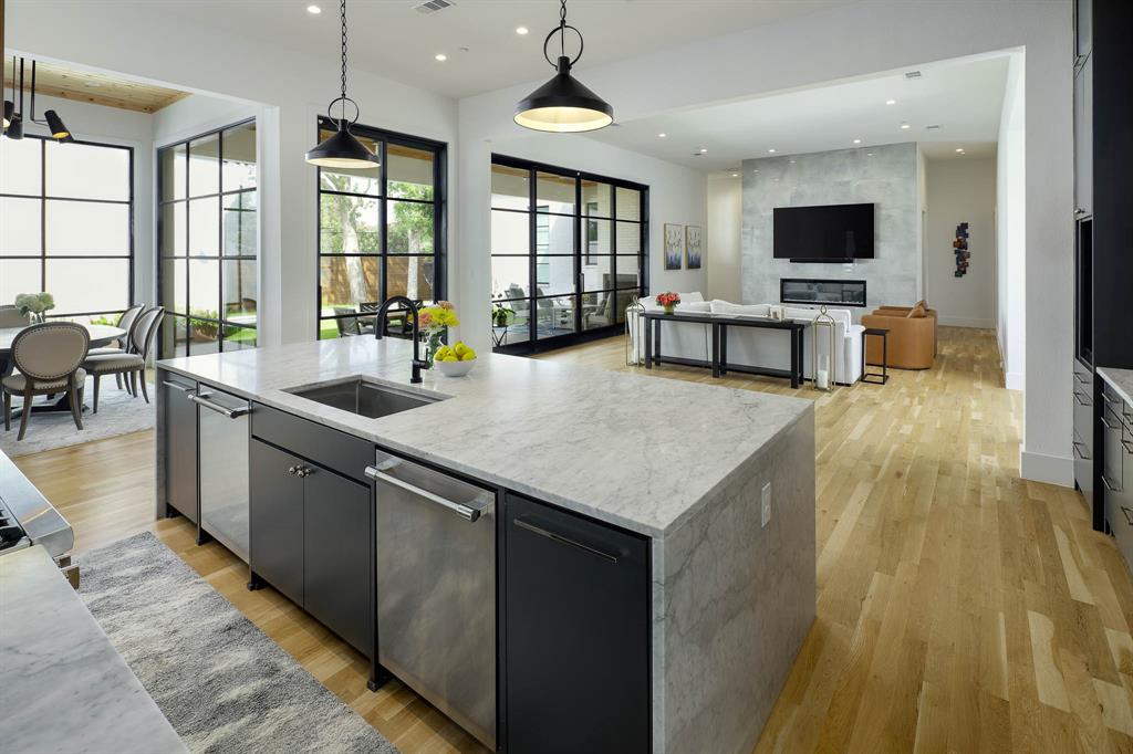 7149 Northaven Road Dallas, TX 75230 - Photo 9 of 25 a large kitchen with sink a counter top space and living room