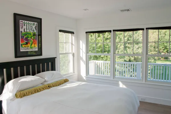 a bedroom with a bed and a painting on the wall