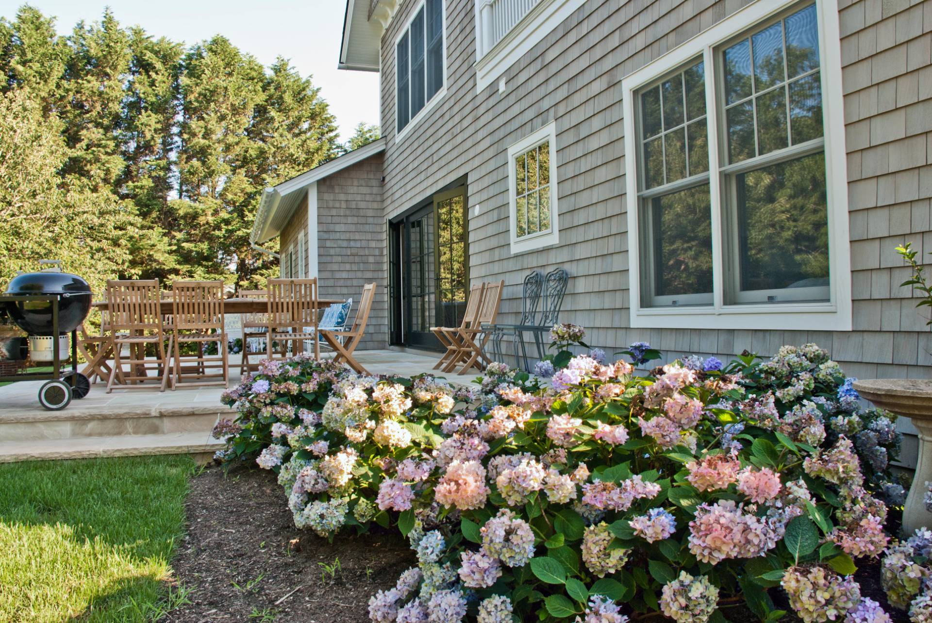 Undisclosed Address Bridgehampton, NY 11932 - Photo 3 of 19 a bunch of flowers in front of the house