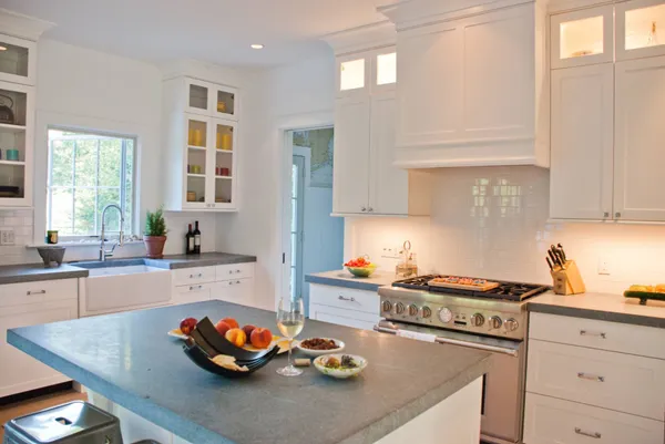 a kitchen with a sink a stove and cabinets