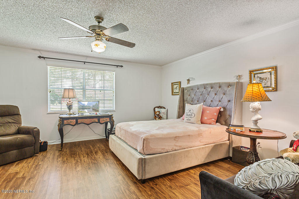 9625 Beauclerc Bluff Road Jacksonville, FL 32257 - Photo 16 of 30 a bedroom with a bed and wooden floor