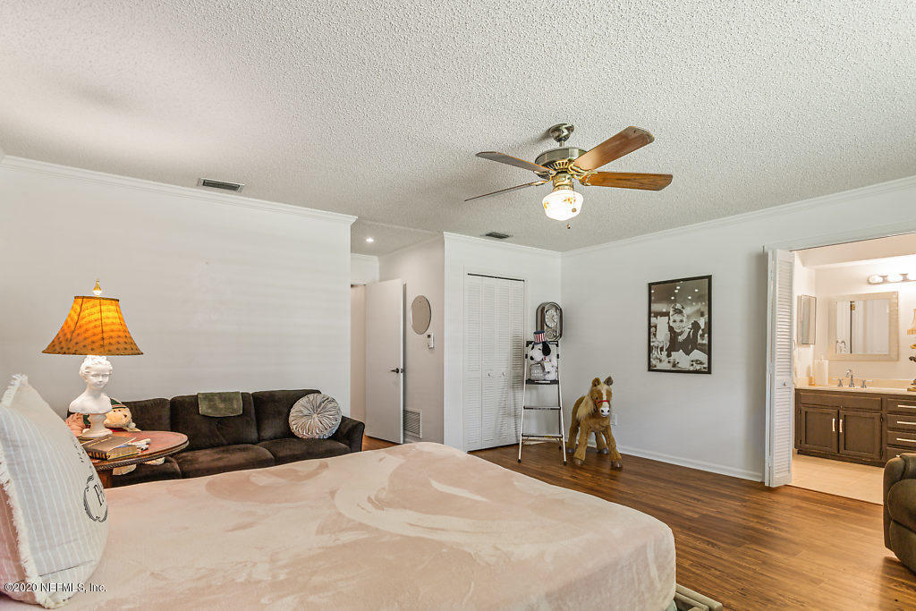 9625 Beauclerc Bluff Road Jacksonville, FL 32257 - Photo 17 of 30 a bedroom with a bed and wooden floor