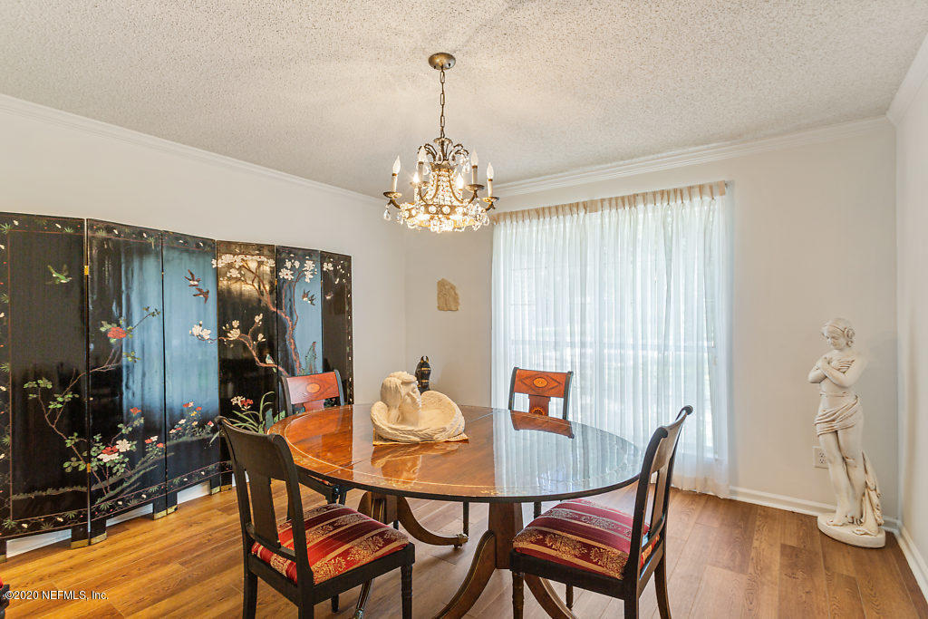 9625 Beauclerc Bluff Road Jacksonville, FL 32257 - Photo 7 of 30 a view of a dining room with furniture window and wooden floor