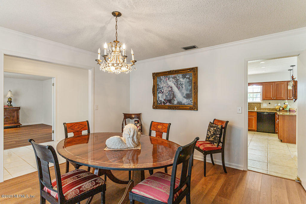 9625 Beauclerc Bluff Road Jacksonville, FL 32257 - Photo 8 of 30 a view of a dining room with furniture and wooden floor