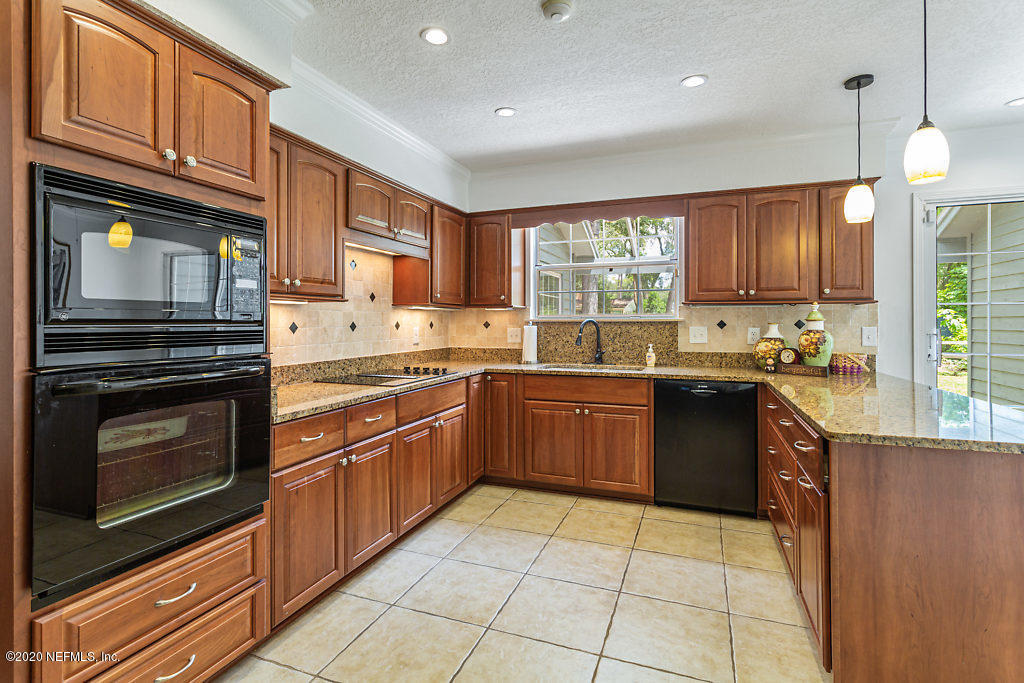 9625 Beauclerc Bluff Road Jacksonville, FL 32257 - Photo 9 of 30 a kitchen with a stove sink and microwave