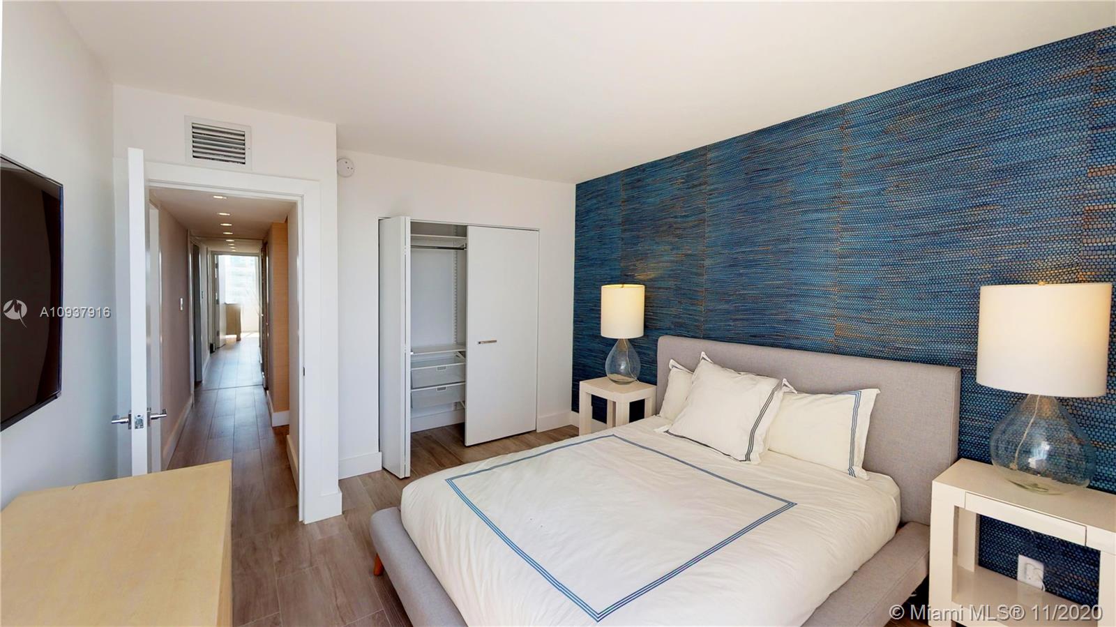 West Avenue Miami Beach, FL 33139 - Photo 15 of 29 a bed room with a bed a mirror and lamp