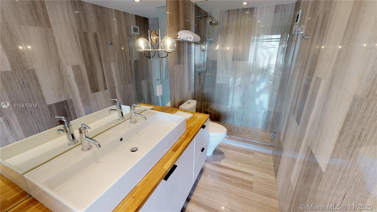 West Avenue Miami Beach, FL 33139 - Photo 20 of 29 a bathroom with a sink and a mirror