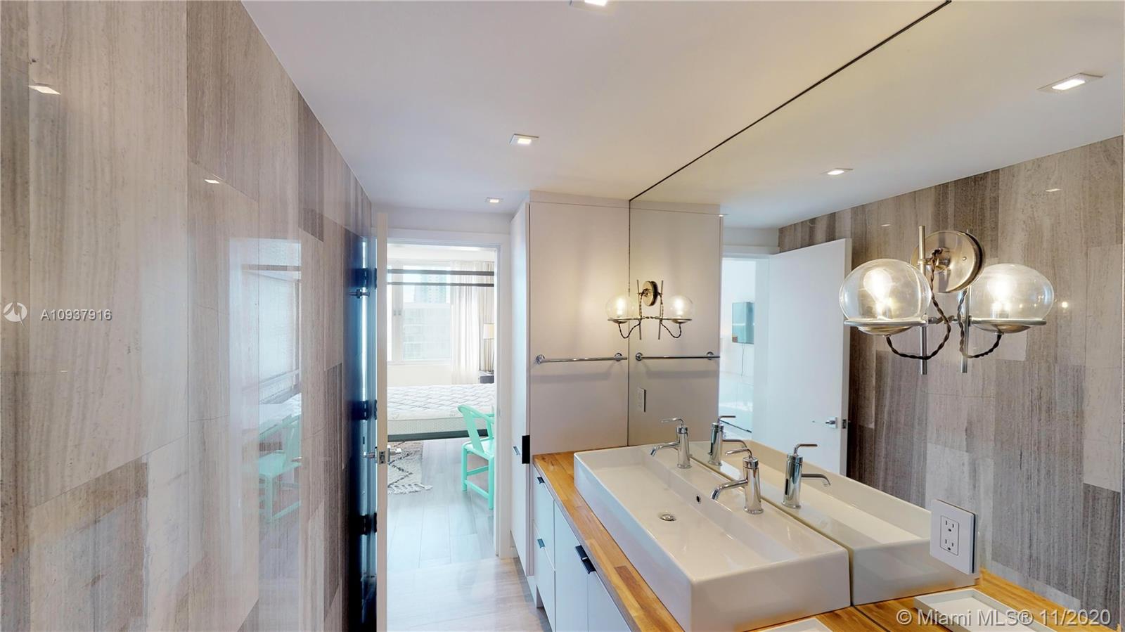 West Avenue Miami Beach, FL 33139 - Photo 24 of 29 a bathroom with a sink a mirror and a shower